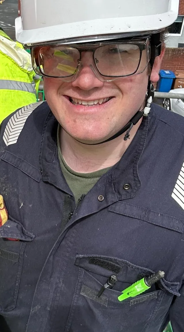 Bradley of Focus Solutions Electrical smiling in a hard hat and safety glasses
